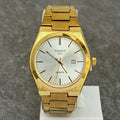 Tissot prx chain watch in gold with white textured dial and date display on a gold metal bracelet