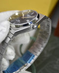 Tissot Prx Chain Watch In Silver Black with stainless steel bracelet held by gloved hand