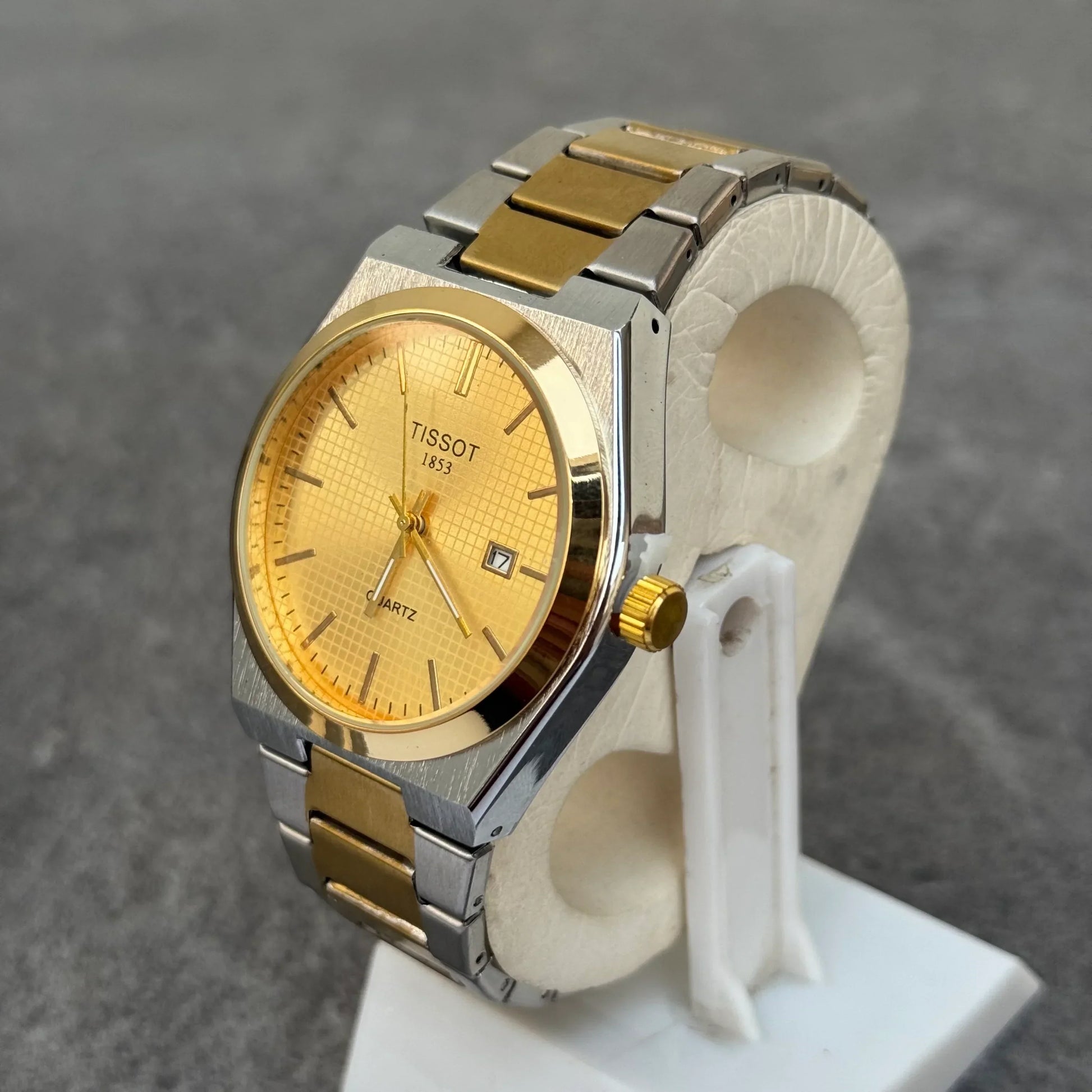 Tissot Prx Two Tone Watch In Gold with stainless steel and gold bracelet on display stand