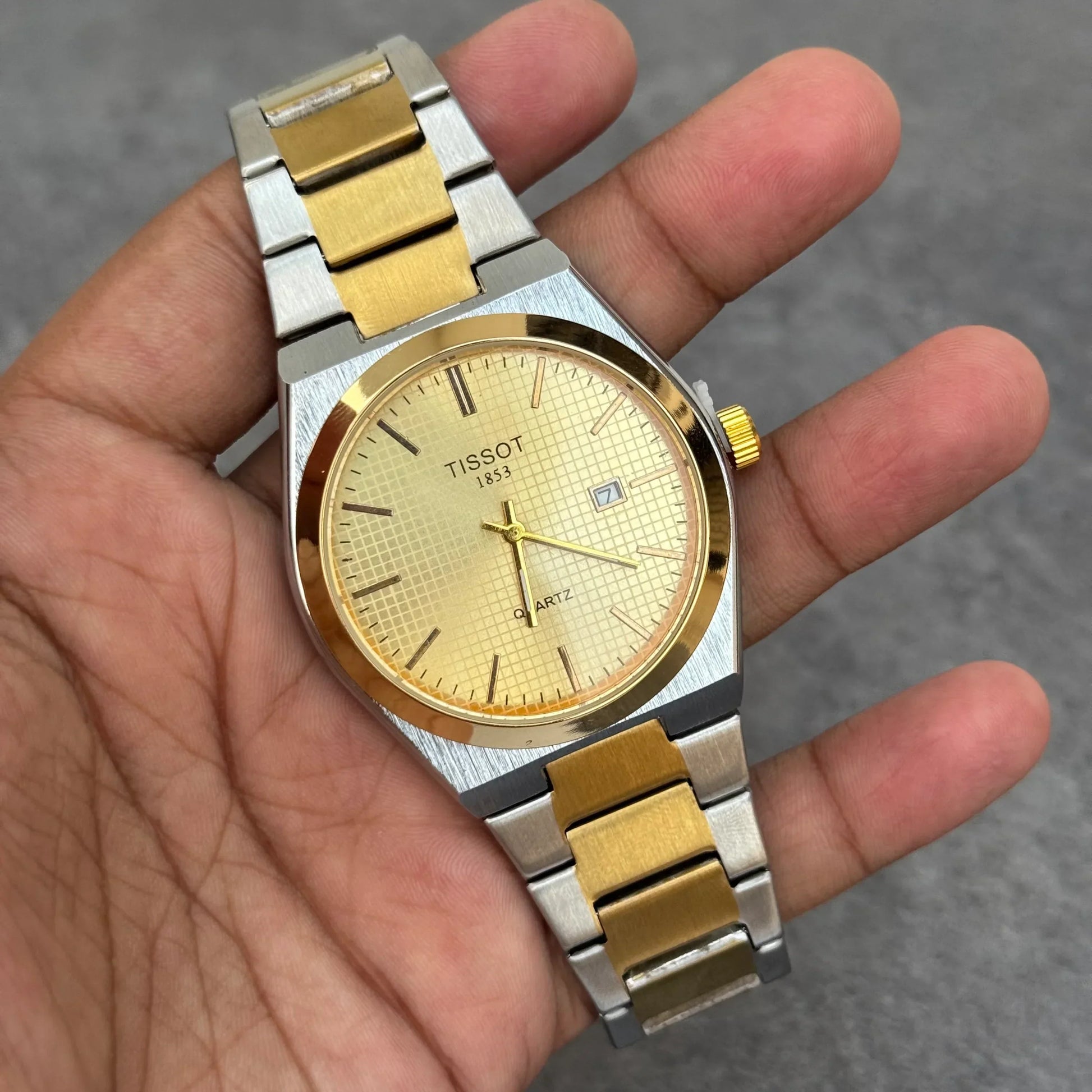 Tissot Prx Two Tone Watch In Gold with stainless steel and gold accents held in hand
