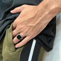 Turkish Ring for Men in Pakistan worn on the hand with a black stone and detailed silver band