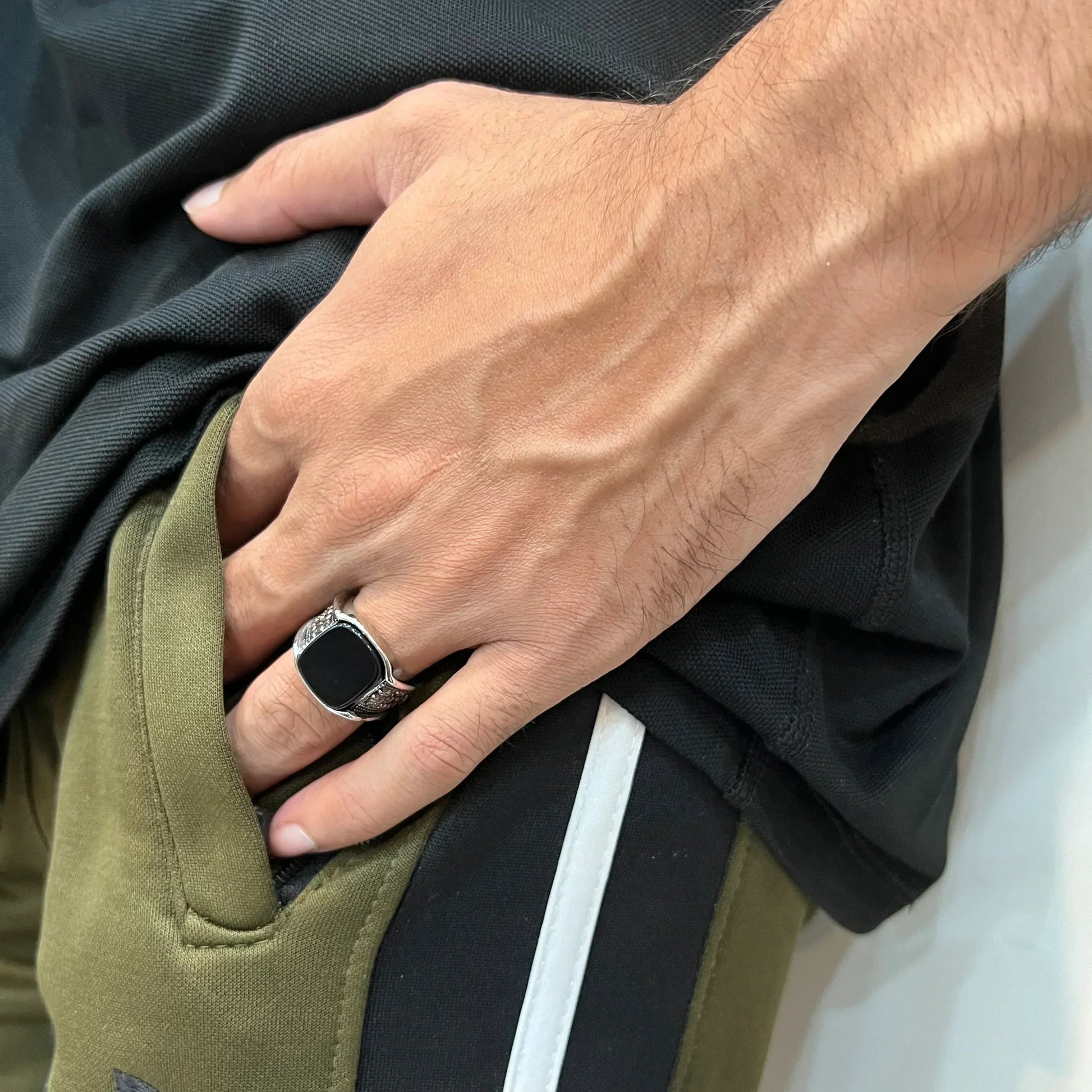 Turkish Ring for Men in Pakistan worn on the hand with a black stone and detailed silver band