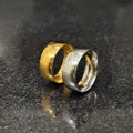 Two classic rings in deal featuring gold and silver bands with textured patterns on a dark surface