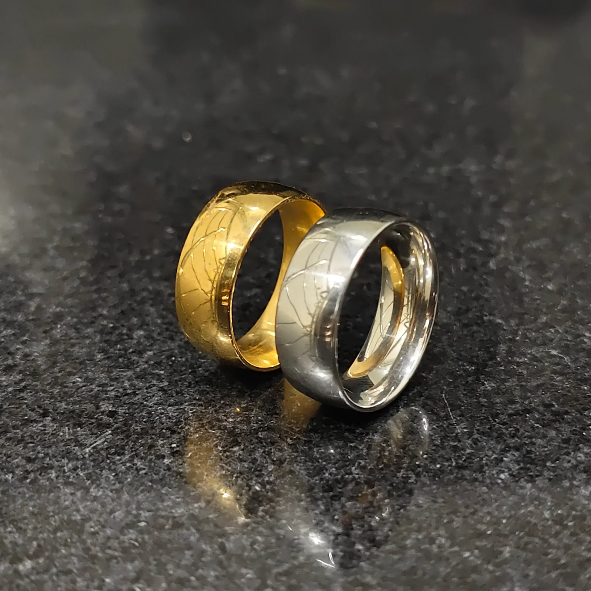 Two classic rings in deal featuring gold and silver bands with textured patterns on a dark surface