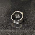Silver Egyptian ring for men with detailed engravings on a dark stone surface