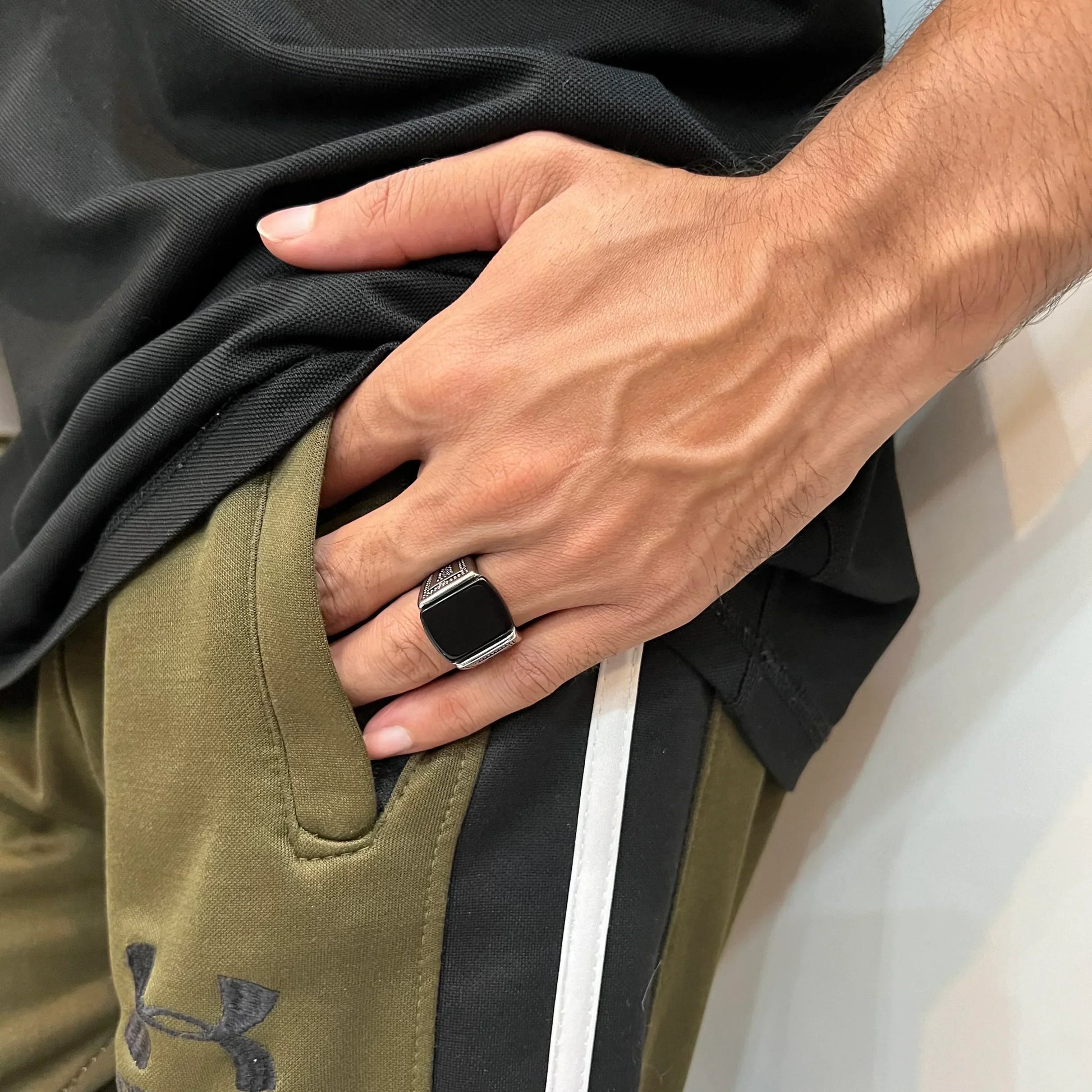 Silver Egyptian ring for men worn on hand with black stone detail paired with casual outfit