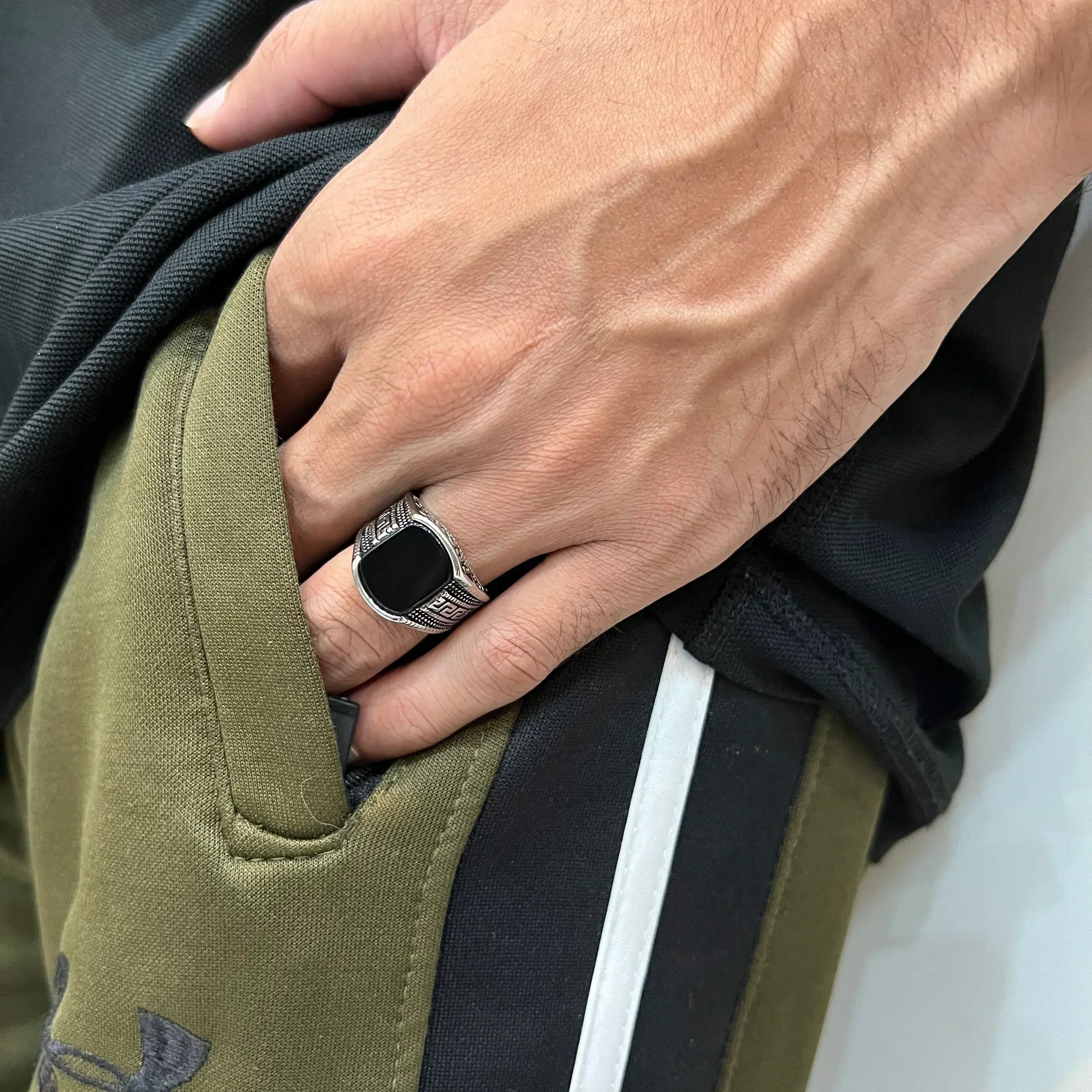 Silver medusa small pattern ring for men worn on hand with olive green and black clothing