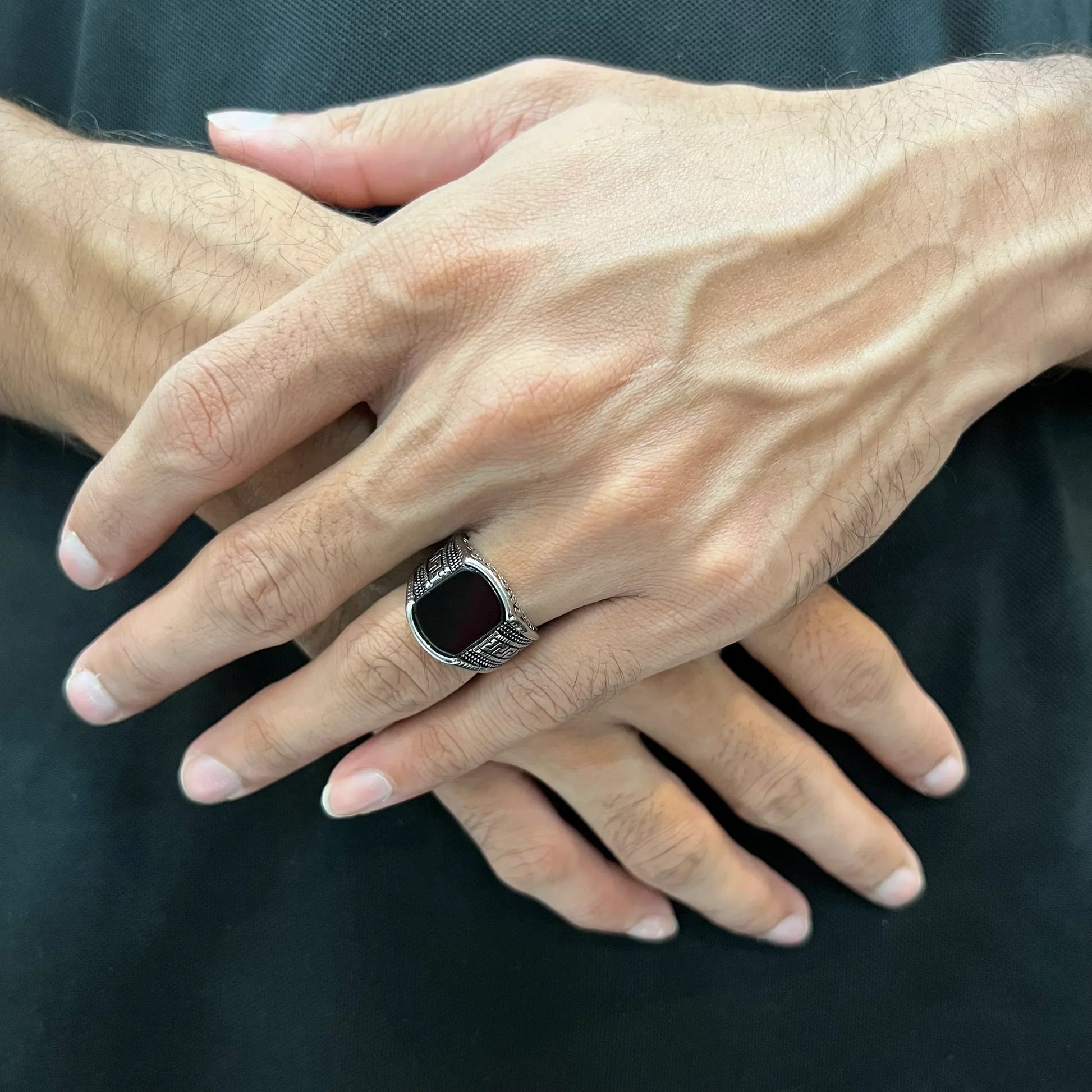 Silver medusa small pattern ring for men worn on hand with black stone centerpiece